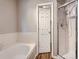 Bright bathroom with a soaking tub and glass enclosed shower showcasing contemporary design at 6827 S Webster St # E, Littleton, CO 80128
