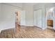 Open bedroom concept featuring wood floors, a double door closet, and an ensuite bathroom at 6827 S Webster St # E, Littleton, CO 80128