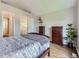 Cozy bedroom featuring warm tone walls, wood flooring, and two dressers for storage at 6827 S Webster St # E, Littleton, CO 80128