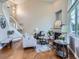 Cozy living room featuring hardwood floors, a fireplace, and comfortable seating at 6827 S Webster St # E, Littleton, CO 80128