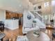 Open-concept living area with hardwood floors, staircase and kitchen access, perfect for modern living at 6827 S Webster St # E, Littleton, CO 80128