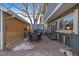 Outdoor patio with a dining table, chairs, and a small shed at 7522 S Rosemary Cir, Englewood, CO 80112