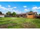 Spacious backyard with a privacy fence, green grass, and access to the home's back entrance at 6698 S Wellington Ct, Centennial, CO 80121