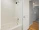 Bathroom features tub, shower, white walls, and access to carpeted room at 6698 S Wellington Ct, Centennial, CO 80121