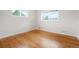 Bright bedroom features hardwood floors, neutral paint, and double hung windows at 6698 S Wellington Ct, Centennial, CO 80121