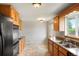 This kitchen features granite countertops, tile floors, natural wood cabinets, and stainless steel appliances at 6698 S Wellington Ct, Centennial, CO 80121