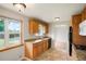 Well-maintained kitchen with granite countertops, tile floors, wood cabinets, and modern appliances at 6698 S Wellington Ct, Centennial, CO 80121