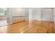 Inviting living area with shiny hardwood floors and natural light and a glimpse of the staircase at 6698 S Wellington Ct, Centennial, CO 80121