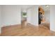 Bright living area featuring gleaming hardwood floors, light-colored walls, and an easy flow into the adjacent kitchen at 6698 S Wellington Ct, Centennial, CO 80121