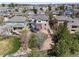 Aerial view of a home in a neighborhood showing the backyard, mature trees, and surrounding houses at 6994 S Fultondale Cir, Aurora, CO 80016