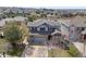 An aerial view showcases the home's architectural design with a three-car garage and landscaped front yard at 6994 S Fultondale Cir, Aurora, CO 80016