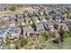 An aerial view displays the neighborhood layout with houses, green spaces, and solar panels on some roofs at 6994 S Fultondale Cir, Aurora, CO 80016