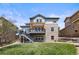 A multi-level deck and stone facade highlight this backyard with a well-manicured lawn at 6994 S Fultondale Cir, Aurora, CO 80016