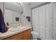 Bathroom with updated vanity, neutral walls, and shower with a curtain at 6994 S Fultondale Cir, Aurora, CO 80016