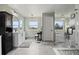 Modern bathroom features dual vanities, a glass shower, and windows with a scenic view at 6994 S Fultondale Cir, Aurora, CO 80016
