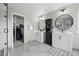 Charming bathroom features tile floors, dual sinks, modern lighting, and a walk-in closet at 6994 S Fultondale Cir, Aurora, CO 80016