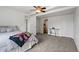 Bedroom featuring a ceiling fan and a view into the en suite bathroom at 6994 S Fultondale Cir, Aurora, CO 80016