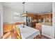 Open dining area adjacent to the kitchen, with hardwood floors, great lighting, and ample cabinet space at 6994 S Fultondale Cir, Aurora, CO 80016