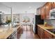 Spacious kitchen featuring granite countertops, stainless steel appliances, and wood floors at 6994 S Fultondale Cir, Aurora, CO 80016