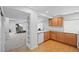 Basement kitchenette with wood cabinets and view of the workout area at 6994 S Fultondale Cir, Aurora, CO 80016