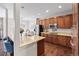 Gourmet kitchen featuring granite counters, stainless steel appliances, and dark hardwood floors at 6994 S Fultondale Cir, Aurora, CO 80016