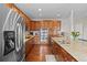 A modern kitchen featuring stainless steel appliances, granite countertops and hardwood floors at 6994 S Fultondale Cir, Aurora, CO 80016