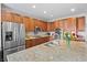 Spacious kitchen with stainless steel appliances, granite counters, and ample cabinet space at 6994 S Fultondale Cir, Aurora, CO 80016
