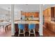 Open kitchen layout with barstool seating, granite counters, stainless appliances, and hardwood floors at 6994 S Fultondale Cir, Aurora, CO 80016