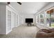 Bright living room with a large window, carpet flooring, a ceiling fan, and built-in shelves at 6994 S Fultondale Cir, Aurora, CO 80016