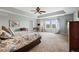 Spacious primary bedroom boasts tray ceilings, a ceiling fan, and plenty of natural light from double windows at 6994 S Fultondale Cir, Aurora, CO 80016
