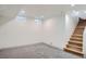 Finished basement featuring new carpeting, recessed lighting, and stairs leading to the upper level at 3975 Yates St, Denver, CO 80212