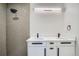 Modern bathroom with a double sink vanity, sleek black fixtures, and a tiled shower with a rainfall showerhead at 3975 Yates St, Denver, CO 80212