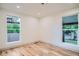 Light-filled bedroom with hardwood floors, recessed lights and large windows offering views of the neighborhood at 3975 Yates St, Denver, CO 80212