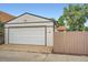 Spacious garage with a white door, a driveway, and adjacent fencing, providing secure parking at 3975 Yates St, Denver, CO 80212