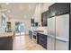 Well-equipped kitchen with stainless steel appliances, dark cabinets, and a sliding door to the backyard at 3975 Yates St, Denver, CO 80212