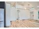 Open-concept living area with hardwood floors, an arched doorway, and an abundance of natural light at 3975 Yates St, Denver, CO 80212