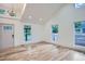 Sunlit living room showcasing hardwood floors, vaulted ceilings, and an abundance of natural light at 3975 Yates St, Denver, CO 80212