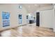 Spacious open living space featuring hardwood floors, high ceilings, and plenty of windows at 3975 Yates St, Denver, CO 80212