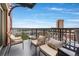 Balcony with comfy wicker seating and a stunning city view at 1950 N Logan St # 905, Denver, CO 80203
