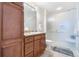 Bathroom features a vanity with a granite countertop and a glass-enclosed shower at 1950 N Logan St # 905, Denver, CO 80203