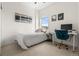Bright bedroom with a comfortable twin bed, city views, and a functional desk area at 1950 N Logan St # 905, Denver, CO 80203