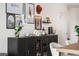 Stylish cabinet with glass doors, displaying decor and glassware in the dining area at 1950 N Logan St # 905, Denver, CO 80203