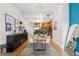 Open-concept dining room with modern decor and view to the kitchen area at 1950 N Logan St # 905, Denver, CO 80203