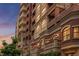 Beautiful red brick building with multiple balconies and decorative elements at sunset at 1950 N Logan St # 905, Denver, CO 80203