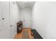 Bright hallway with hardwood floors features a shoe rack, entryway bench, and white walls at 1950 N Logan St # 905, Denver, CO 80203