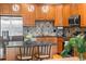 Stylish kitchen featuring stainless steel appliances, a granite island, and modern pendant lighting at 1950 N Logan St # 905, Denver, CO 80203
