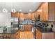 A modern kitchen featuring stainless steel appliances and granite countertops at 1950 N Logan St # 905, Denver, CO 80203