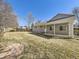 Fenced backyard with lush green grass and a covered patio perfect for outdoor entertaining at 13853 W 66Th Pl, Arvada, CO 80004