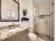 Modern bathroom features granite counters, glass shower, and a stylish design for a luxurious experience at 13853 W 66Th Pl, Arvada, CO 80004