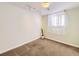 Cozy bedroom with plush carpeting, natural light, and neutral walls provides a serene and comfortable space at 13853 W 66Th Pl, Arvada, CO 80004